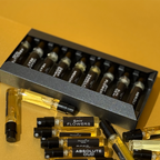 Collection of perfume bottles with visible brand names on a yellow background, Mood'or Perfumes fragrance discovery box
