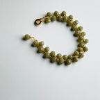 Green beaded bracelet on a white background
