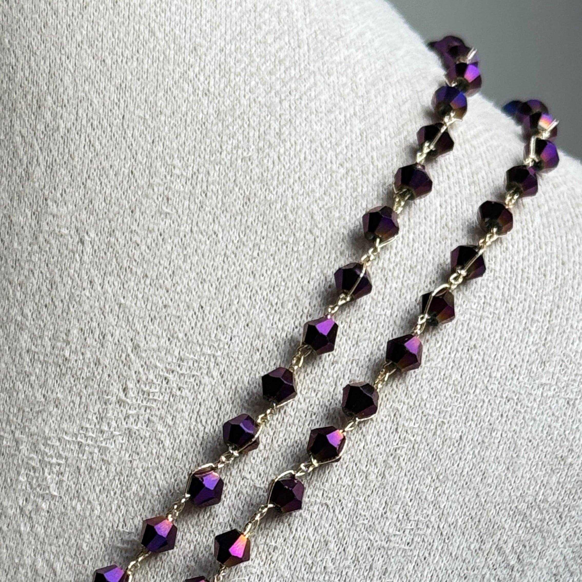 Necklace with purple beads on a light gray background