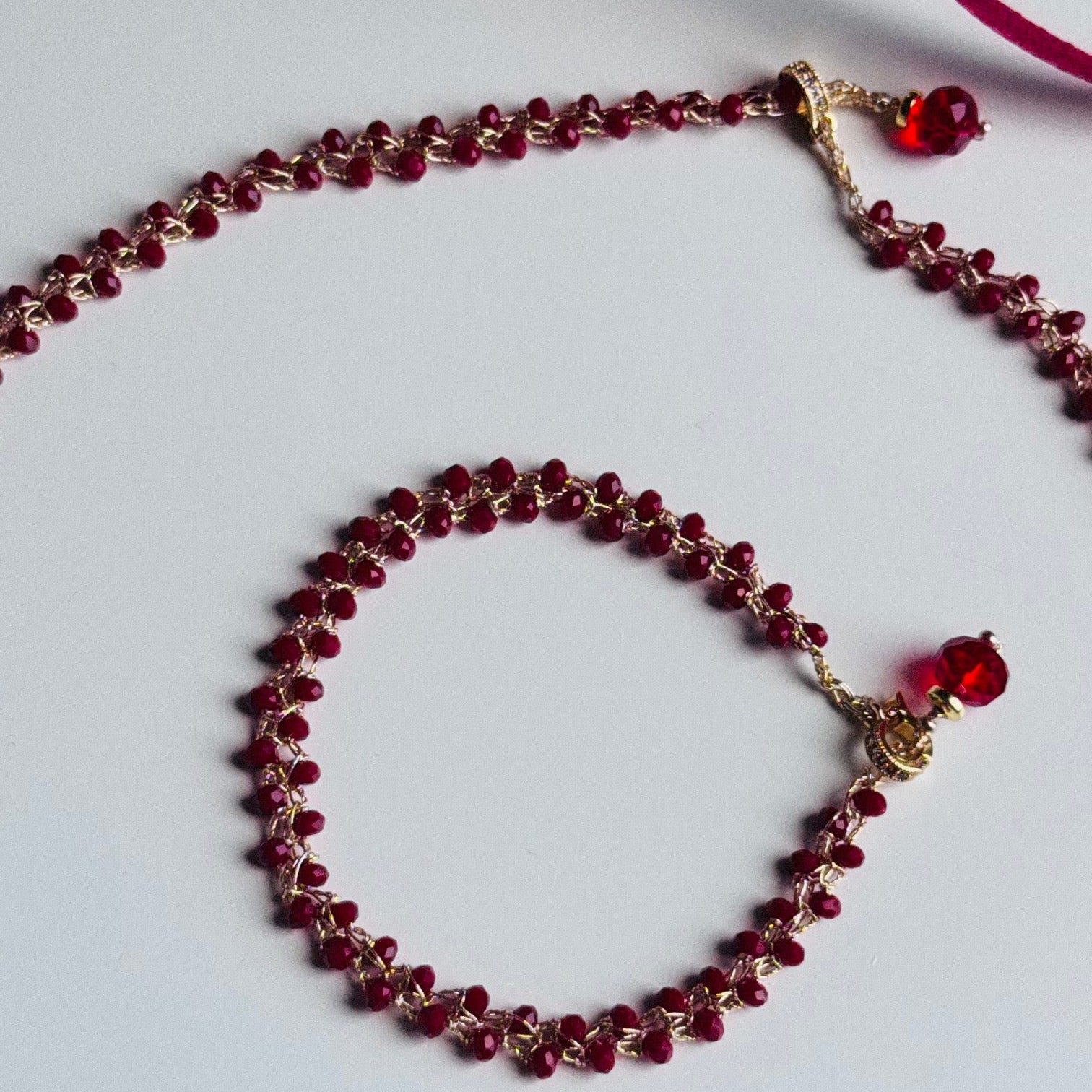 nerta vąšeliu iš auskinio atspalvio sidabru dengt siūlų ir raudonų smulkių karoliukų apyrankė iš arti